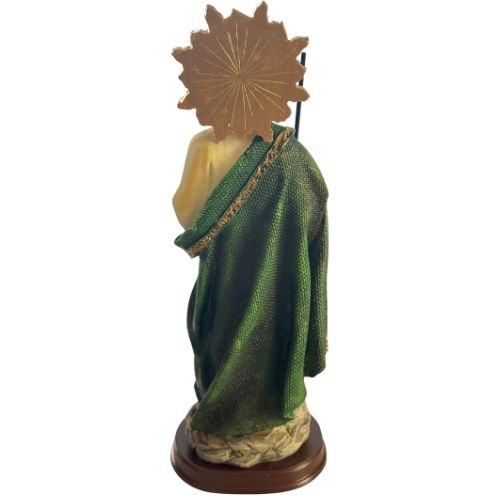 Statue of a figure draped in green with a gold halo on a white background