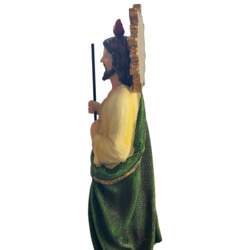Statue of a figure in green and yellow robes holding a staff on a white background