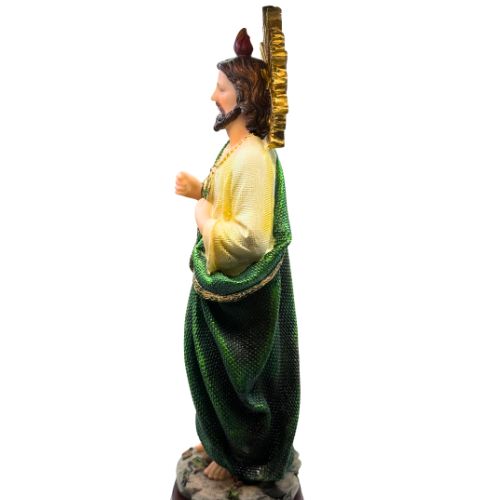 Statue of a figure in green and yellow attire on a white background