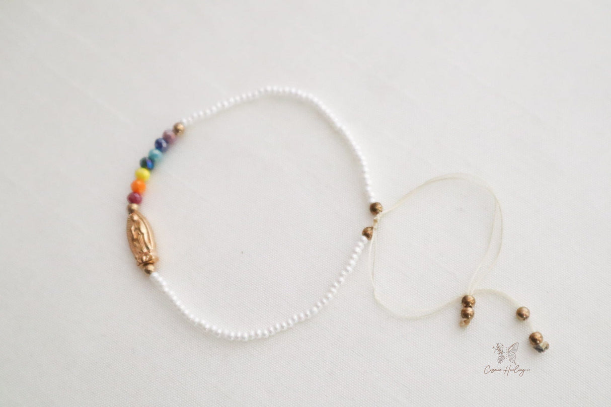 Charming white thread bracelet with Seven Chakra beads and Guadalupe pendant
