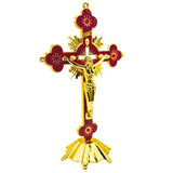 Decorative cross with gold and red details on a white background