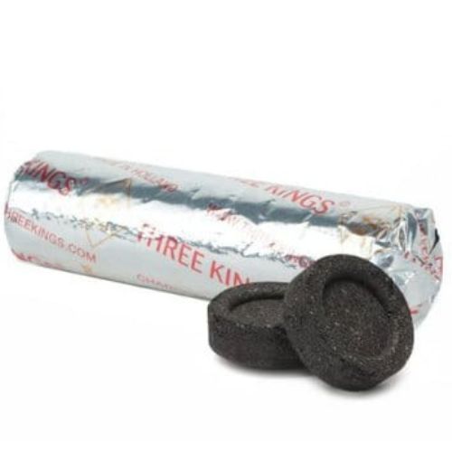 Roll of Three Kings branded material with two charcoal tablets on a white background