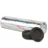 Roll of Three Kings branded material with two charcoal tablets on a white background