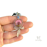 Clear quartz and rose quartz wire-wrapped crystal on a Tree of Life pendant