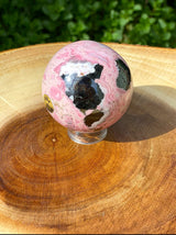 Polished Peruvian Rhodonite crystal sphere