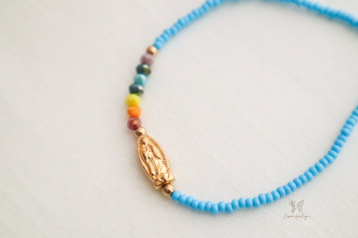 Blue dainty bracelet showcasing Seven Chakras & Virgen de Guadalupe pendant