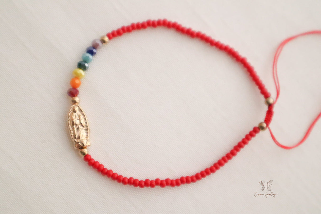 Red dainty bracelet showcasing Seven Chakras & Virgen de Guadalupe pendant